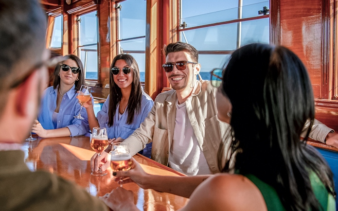 Group enjoying drinks on a catamaran in Barcelona.