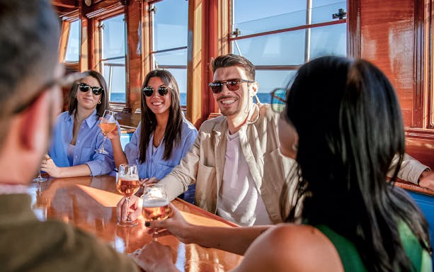 Group enjoying drinks on a catamaran in Barcelona.