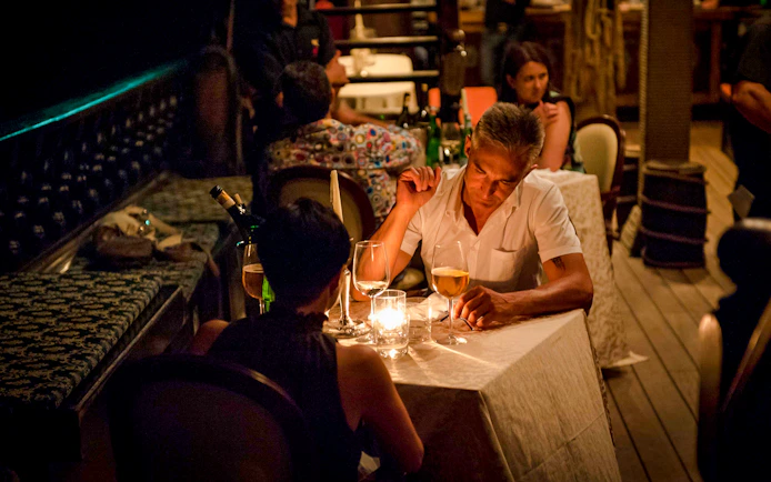 Couple dining by candlelight on a Galleon Dinner Cruise in Venice.