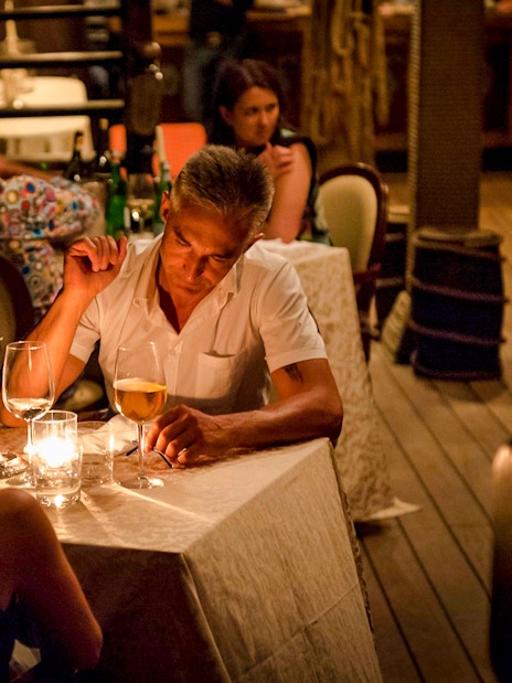 Couple dining by candlelight on a Galleon Dinner Cruise in Venice.