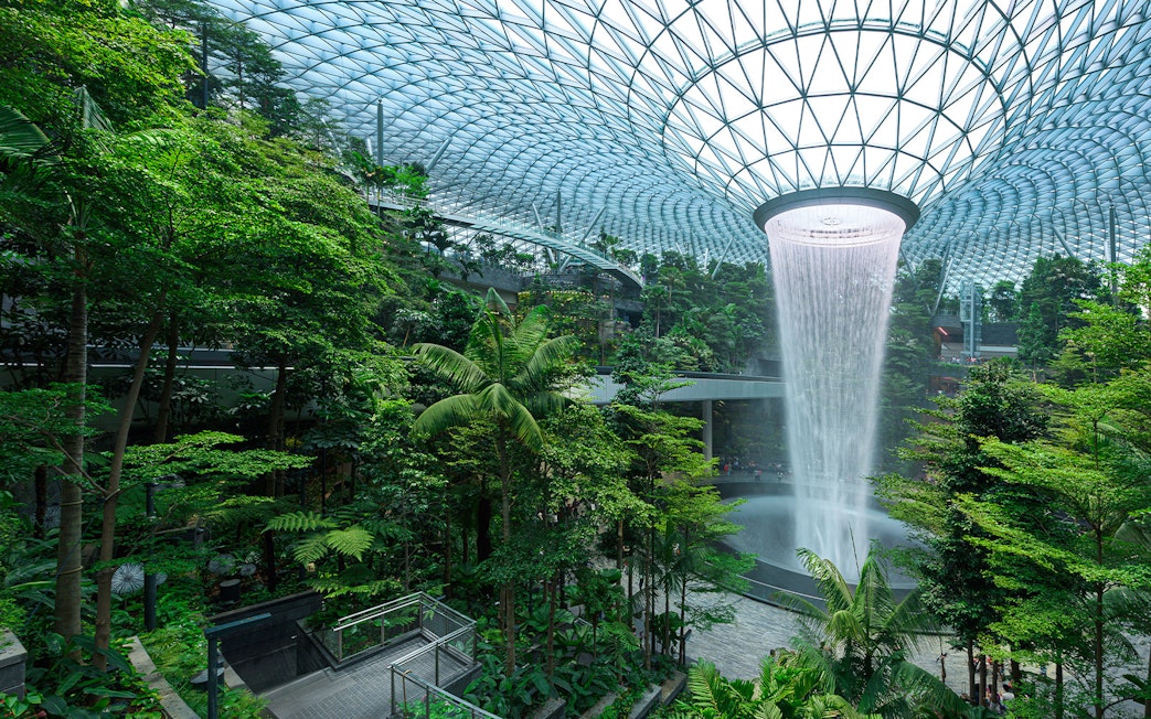 Indoor tropical forest with waterfall at Jewel Changi, Singapore.