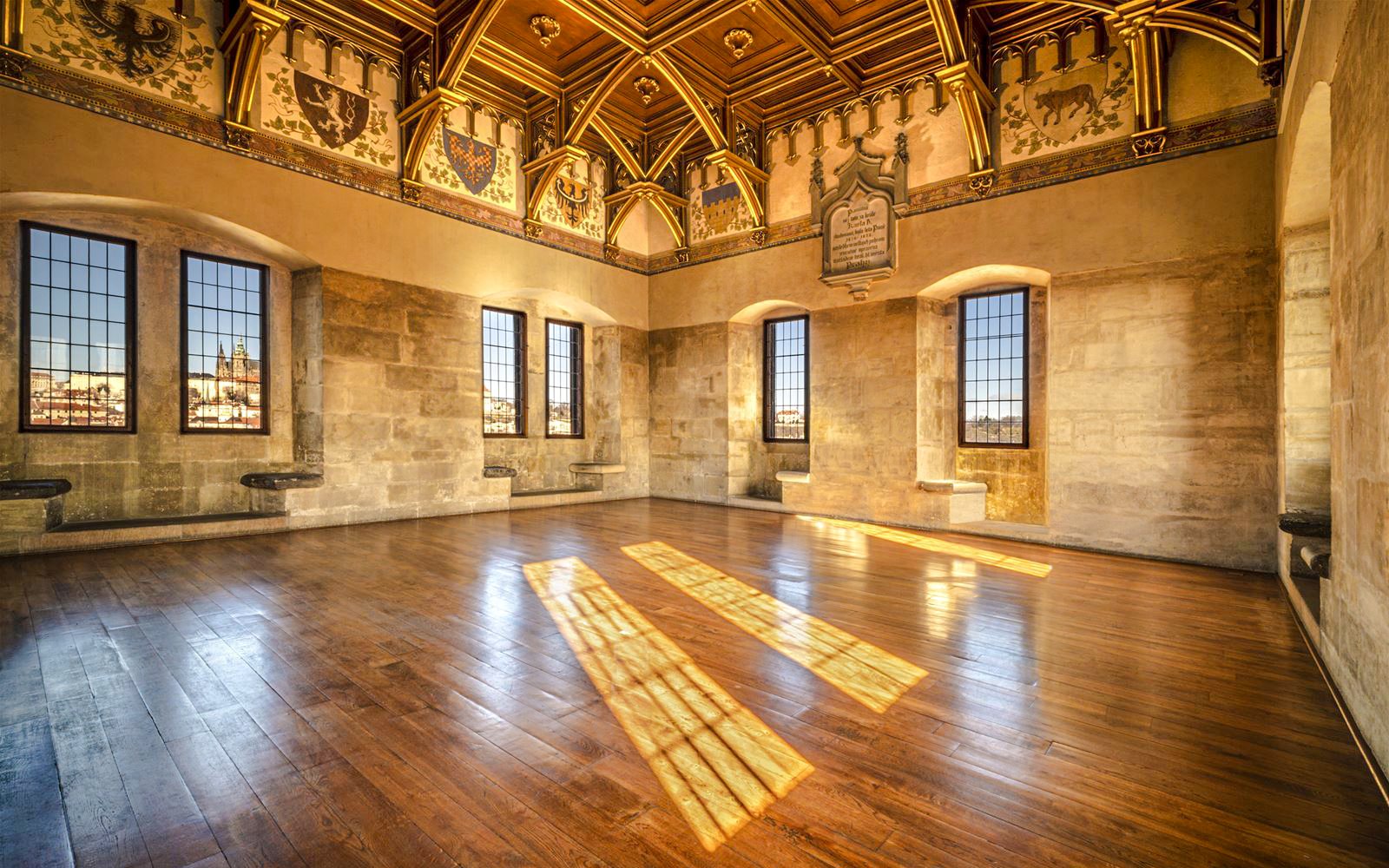 Interior view of Old Town Bridge Tower with ornate ceiling and large windows.