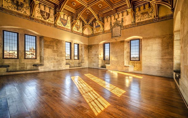 Interior view of Old Town Bridge Tower with ornate ceiling and large windows.