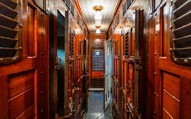Historic train carriage interior at Pietrarsa Railway Museum, Naples.