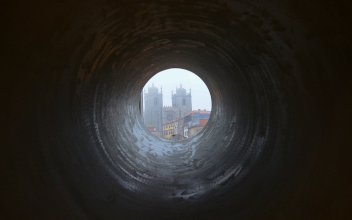 View of Porto Cathedral through a circular tunnel, Porto, Portugal.