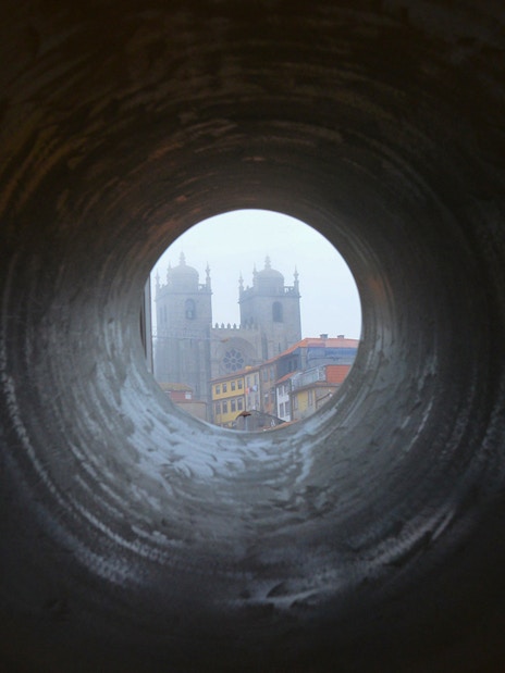 View of Porto Cathedral through a circular tunnel, Porto, Portugal.