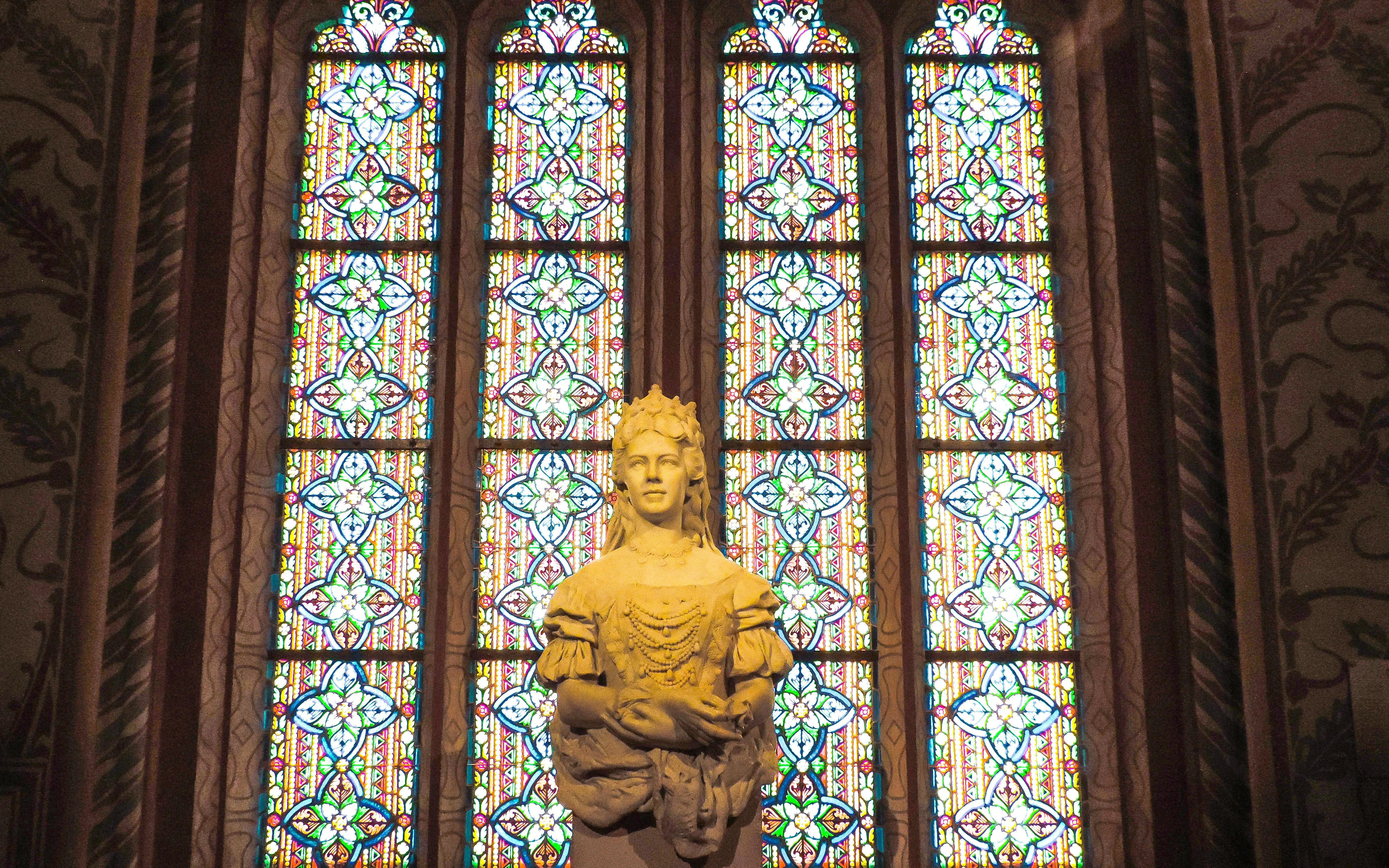 Sculpture of Empress Elisabeth in front of stained glass, Matthias Church, Budapest.