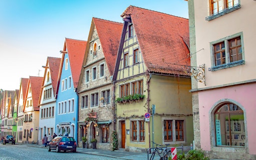 Colorful medieval buildings on a cobblestone street in Rothenburg, Germany.