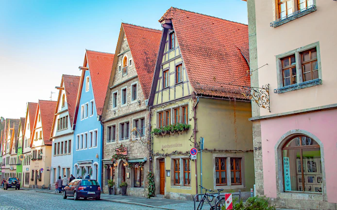 Colorful medieval buildings on a cobblestone street in Rothenburg, Germany.