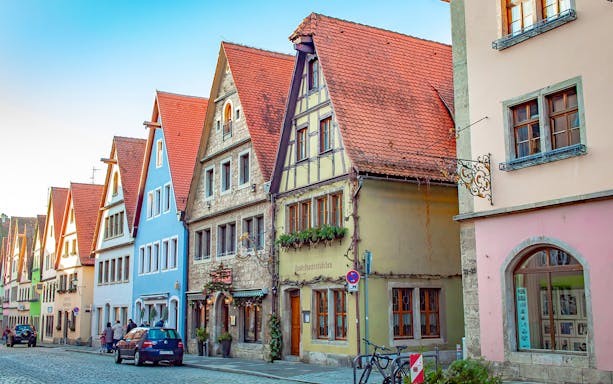 Colorful medieval buildings on a cobblestone street in Rothenburg, Germany.