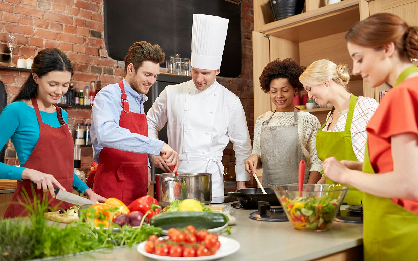 Tourists learning to make traditional Italian pasta in a Rome cooking class.