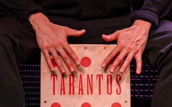 Hands playing a cajón at Los Tarantos Flamenco Show.