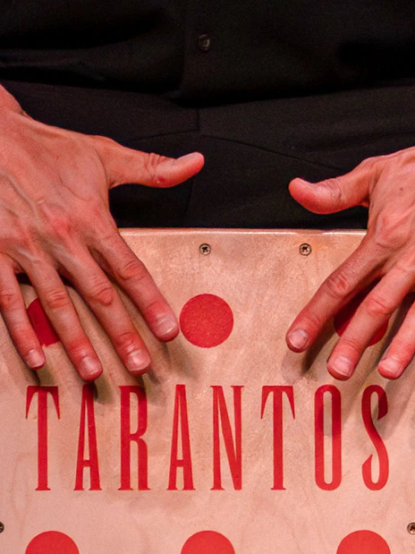Hands playing a cajón at Los Tarantos Flamenco Show.