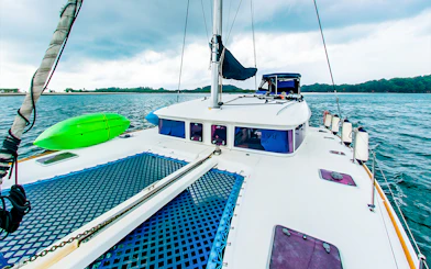 Private yacht charter deck with kayak on open sea.