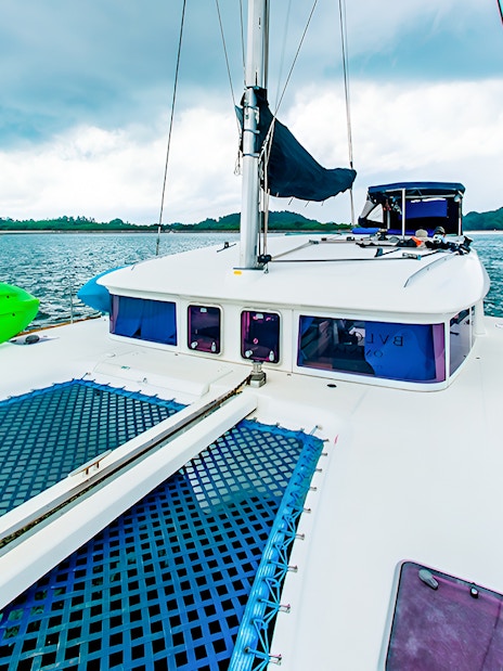 Private yacht charter deck with kayak on open sea.