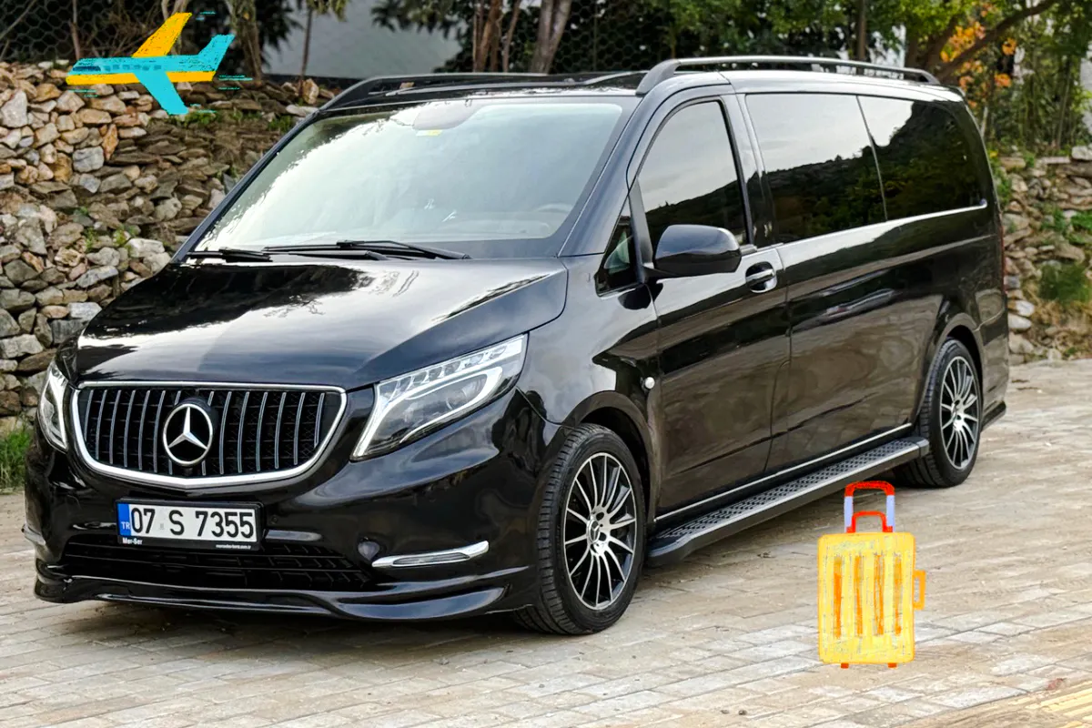 Black luxury van for VIP airport transfer in Antalya, parked on a stone driveway.