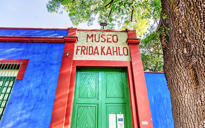 Frida Kahlo Museum entrance with blue walls and green door in Mexico City.