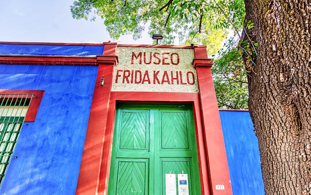 Frida Kahlo Museum entrance with blue walls and green door in Mexico City.