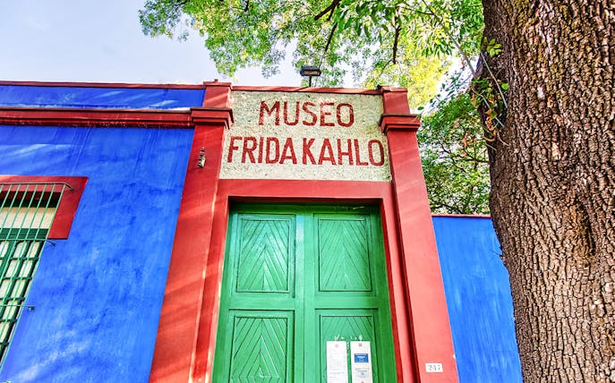 Frida Kahlo Museum entrance with blue walls and green door in Mexico City.