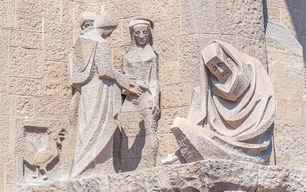 Sculptures on the Sagrada Familia Passion Facade in Barcelona, depicting biblical figures.