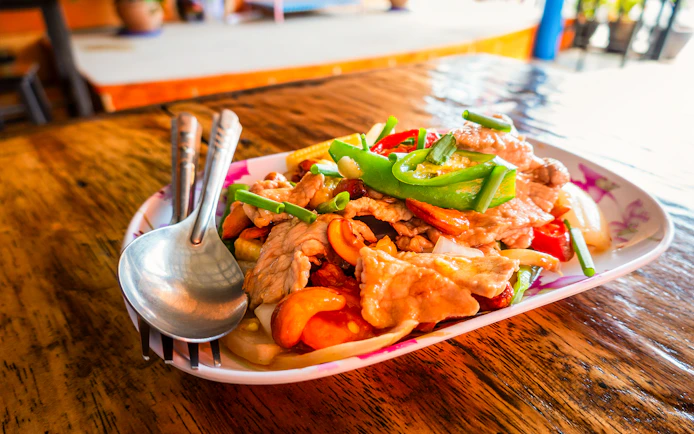 Stir-fried pork with vegetables served on a plate during Mae Ping River Cruise lunch.