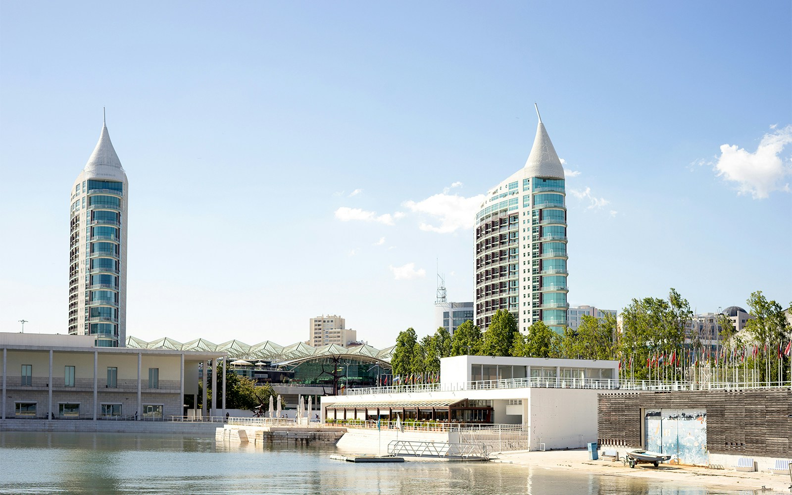 Parque das Nacoes Lisbon tour bus near modern architecture and waterfront.