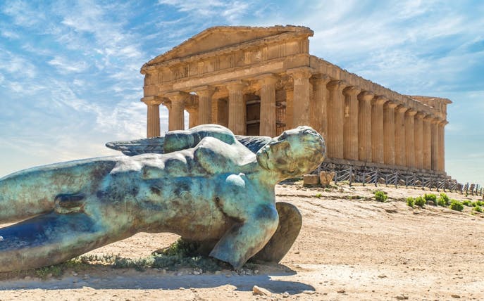 Ancient temple and fallen statue at Valley of Temples, Agrigento, Sicily.