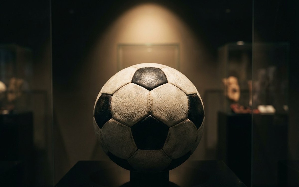 Football displayed at Casa Milan museum exhibit.