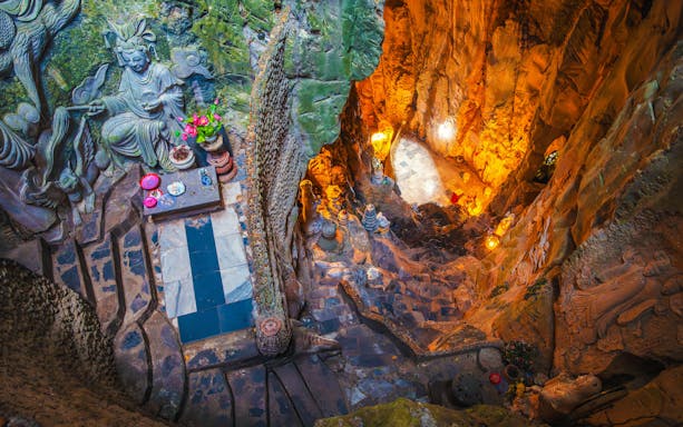 Interior view of Am Phu Cave with stone carvings and altar, Marble Mountains, Đà Nẵng, Vietnam.