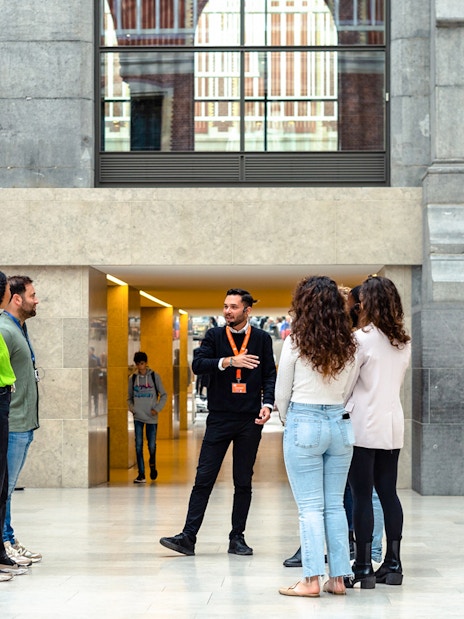 Group listening to a guide inside the Rijksmuseum, Amsterdam.