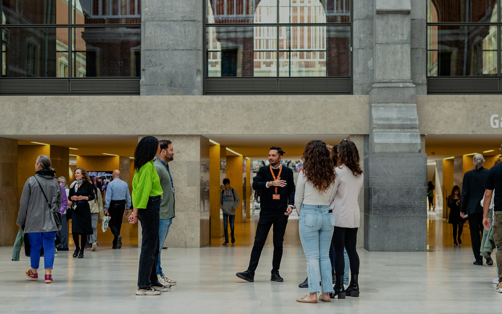 Group listening to a guide inside the Rijksmuseum, Amsterdam.