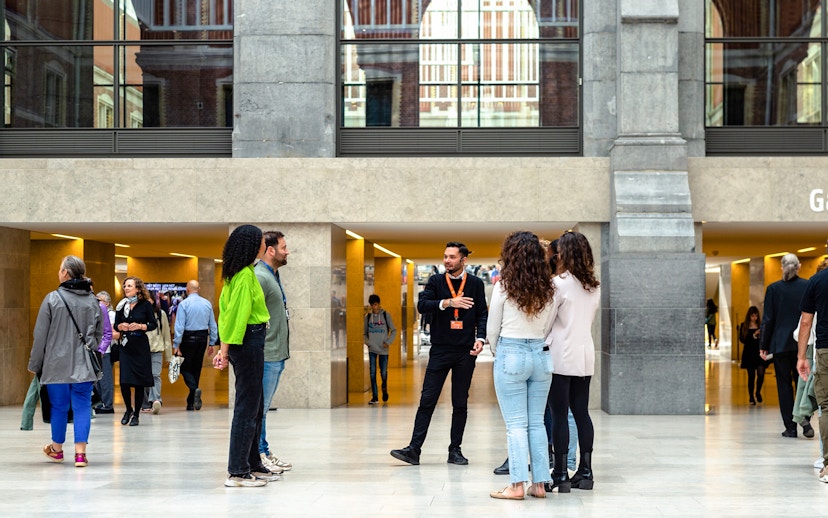 Group listening to a guide inside the Rijksmuseum, Amsterdam.