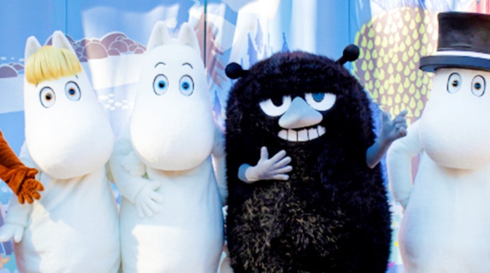 Characters from Moomin Valley Park on stage in front of a colorful backdrop.