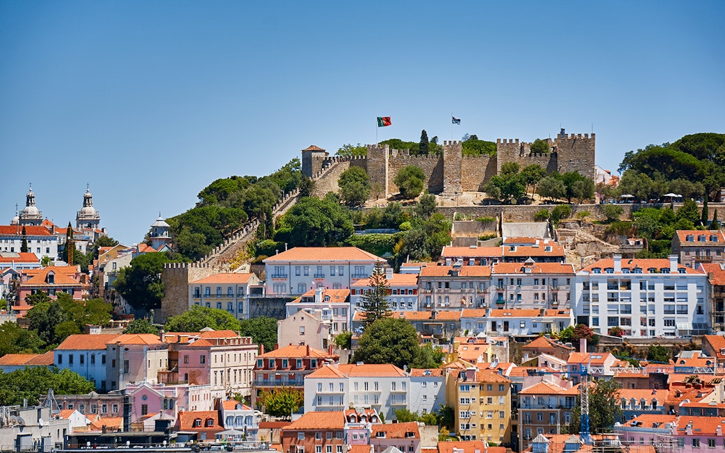 St. George’s Castle overlooking Lisbon with historic buildings in the foreground.