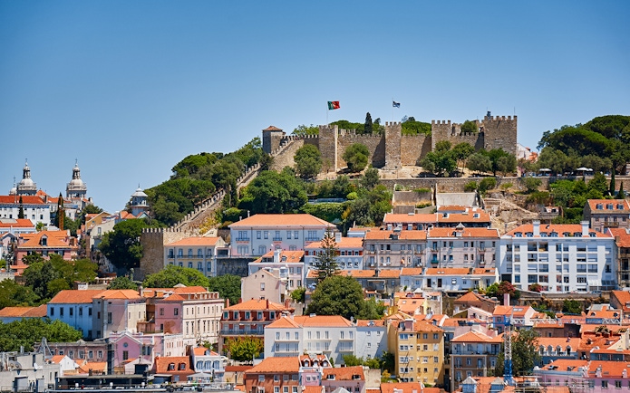 St. George’s Castle overlooking Lisbon with historic buildings in the foreground.