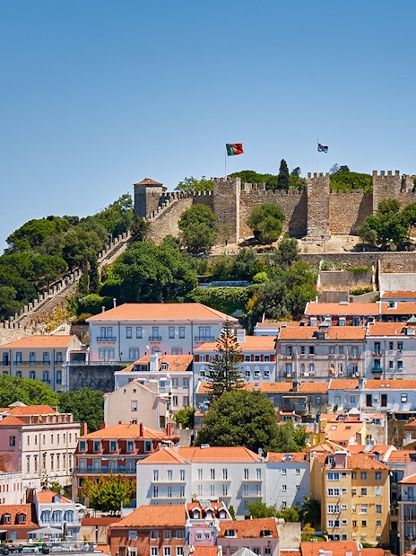 St. George’s Castle overlooking Lisbon with historic buildings in the foreground.