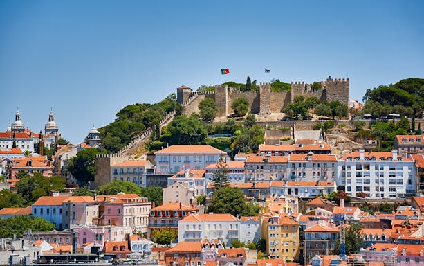 St. George’s Castle overlooking Lisbon with historic buildings in the foreground.