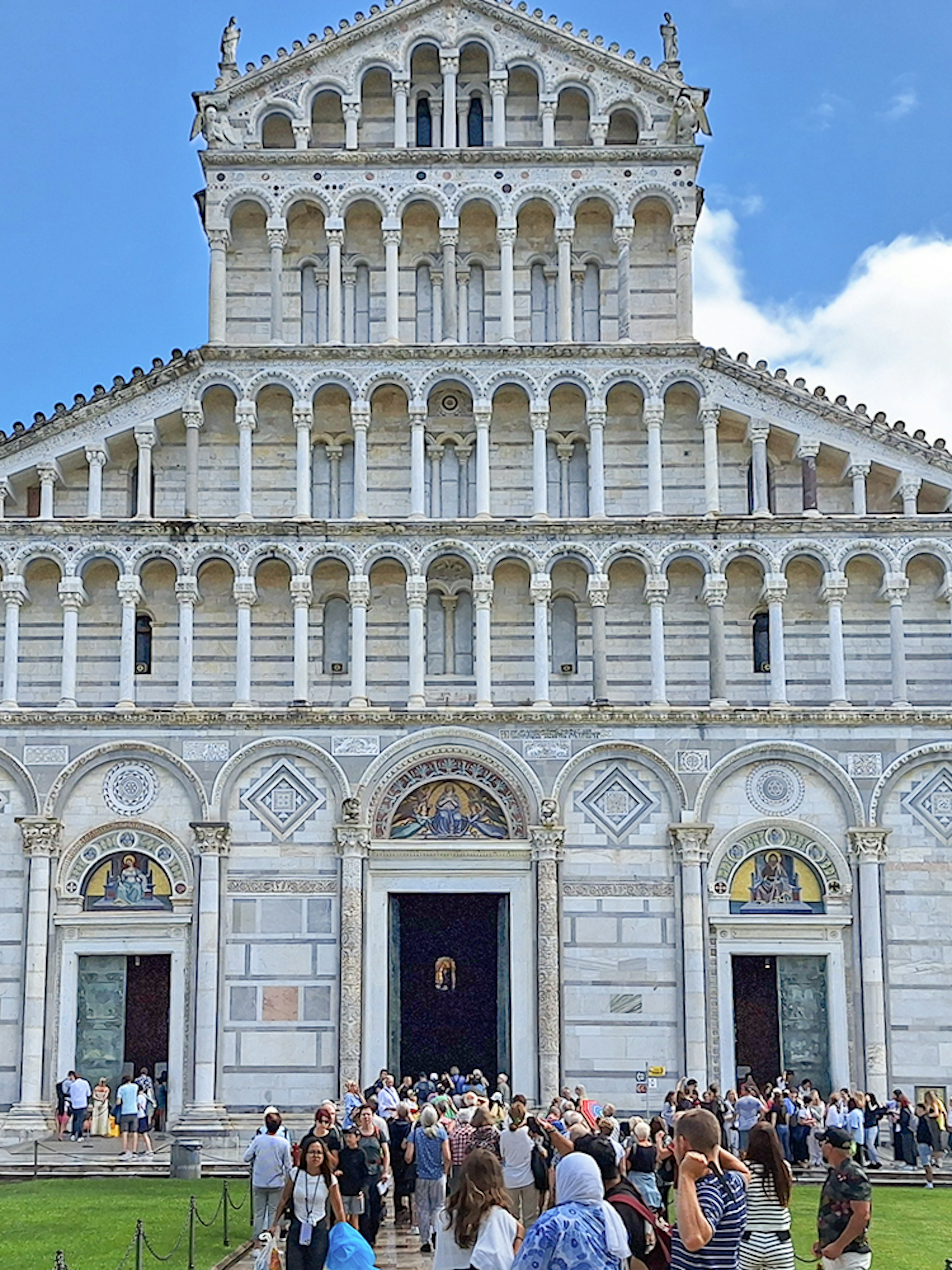Visitors entering Pisa Cathedral in Italy.