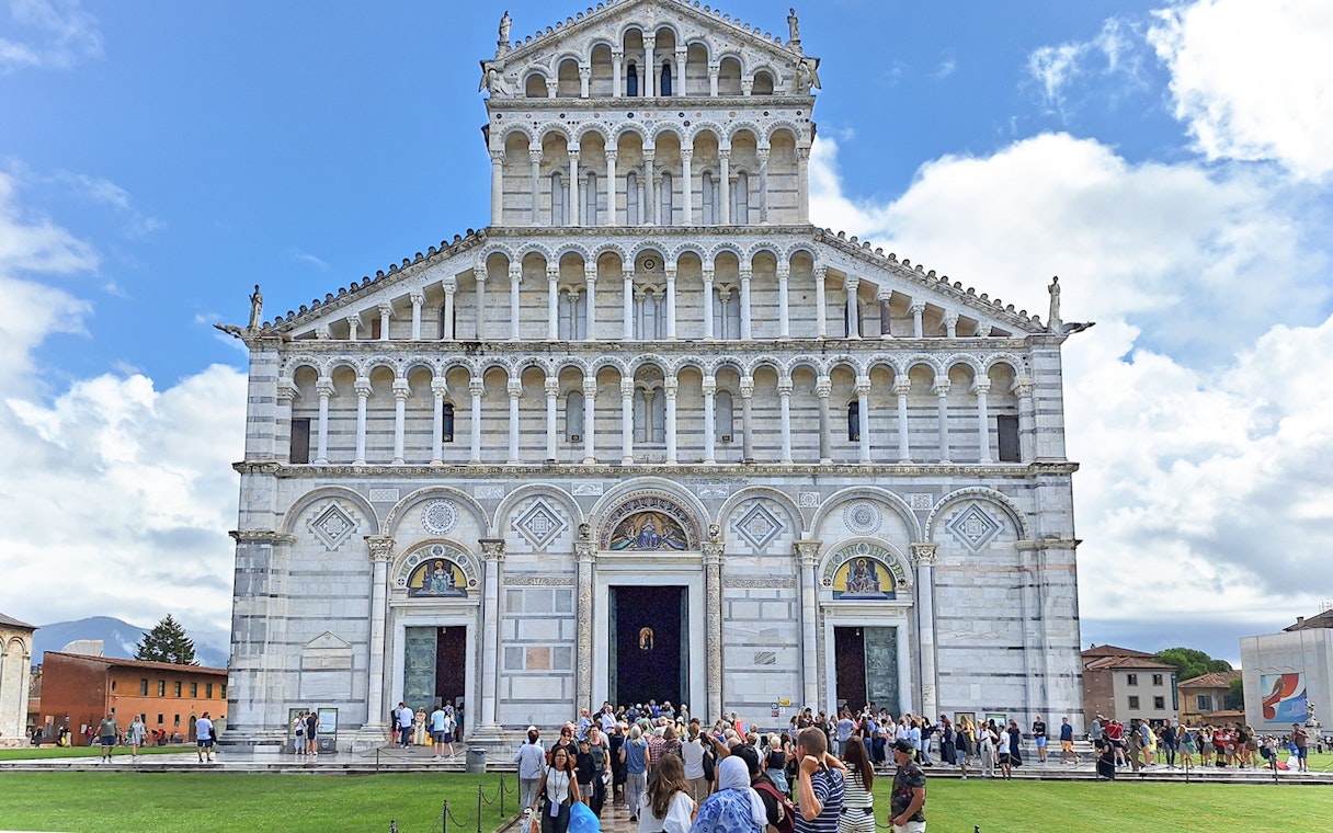 Visitors entering Pisa Cathedral in Italy.