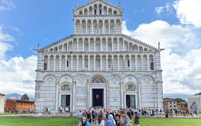 Visitors entering Pisa Cathedral in Italy.