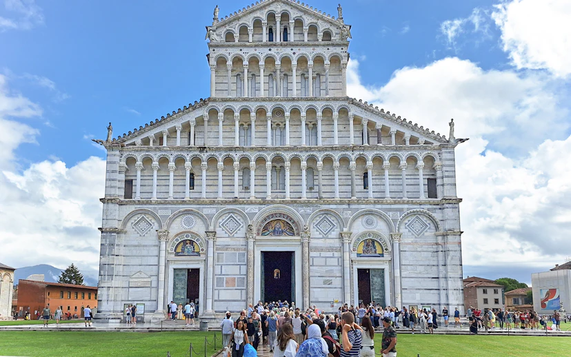Visitors entering Pisa Cathedral in Italy.