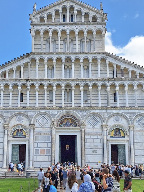 Visitors entering Pisa Cathedral in Italy.