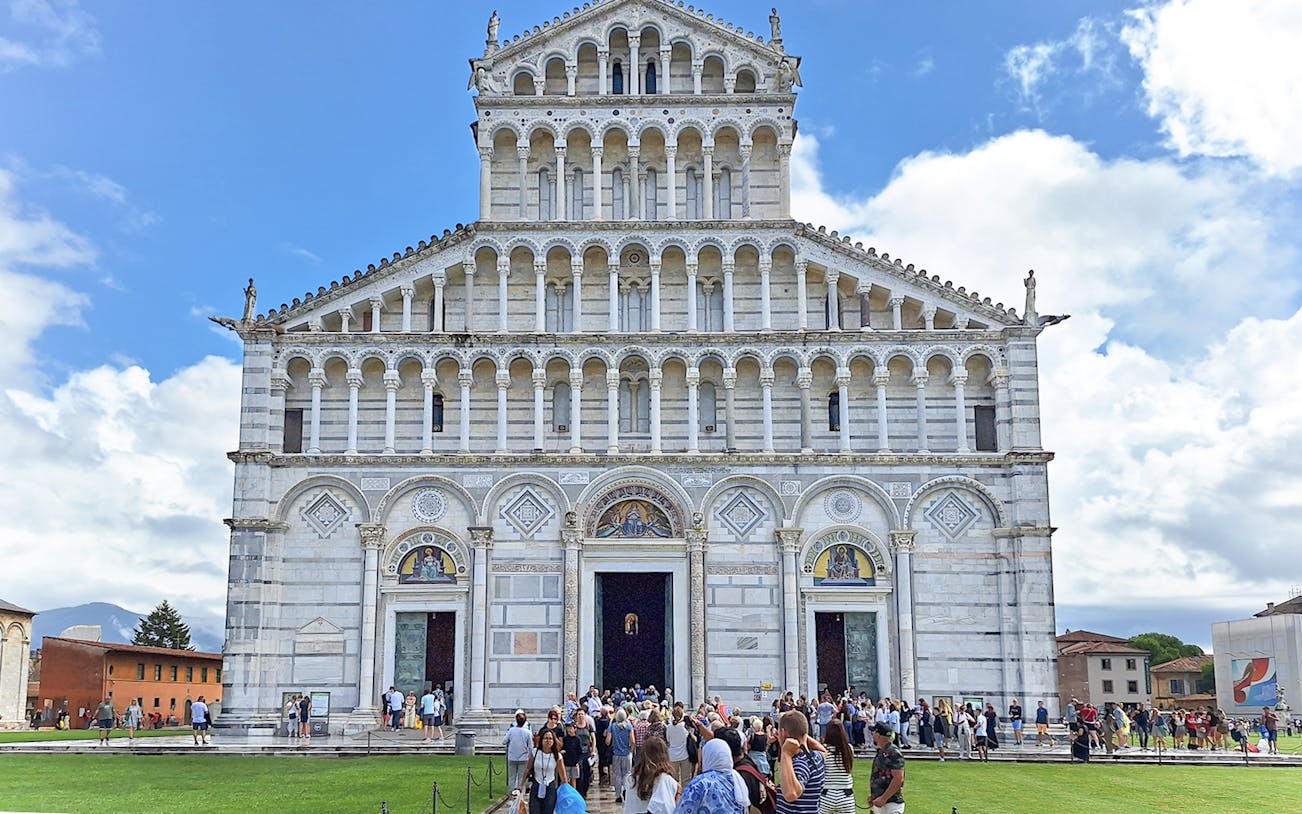 Visitors entering Pisa Cathedral in Italy.