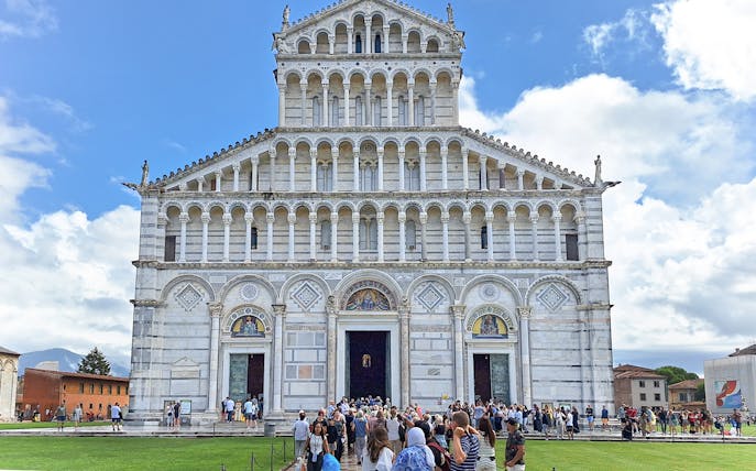 Visitors entering Pisa Cathedral in Italy.