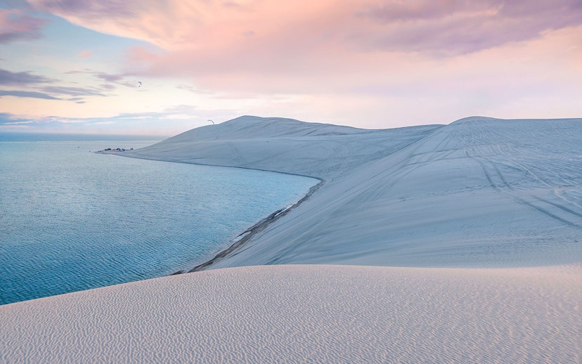 Sunrise over dunes and inland sea in Sea Line Desert near Doha, Qatar.