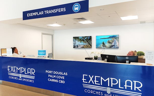 Exemplar Transfers desk at Cairns Airport for shared transfer services to Port Douglas and Palm Cove.