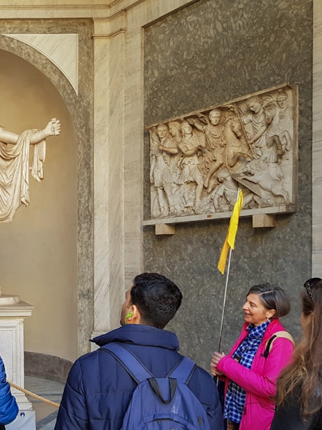 Tourists with guide near Statue of Apollo Belvedere, Vatican Museum.
