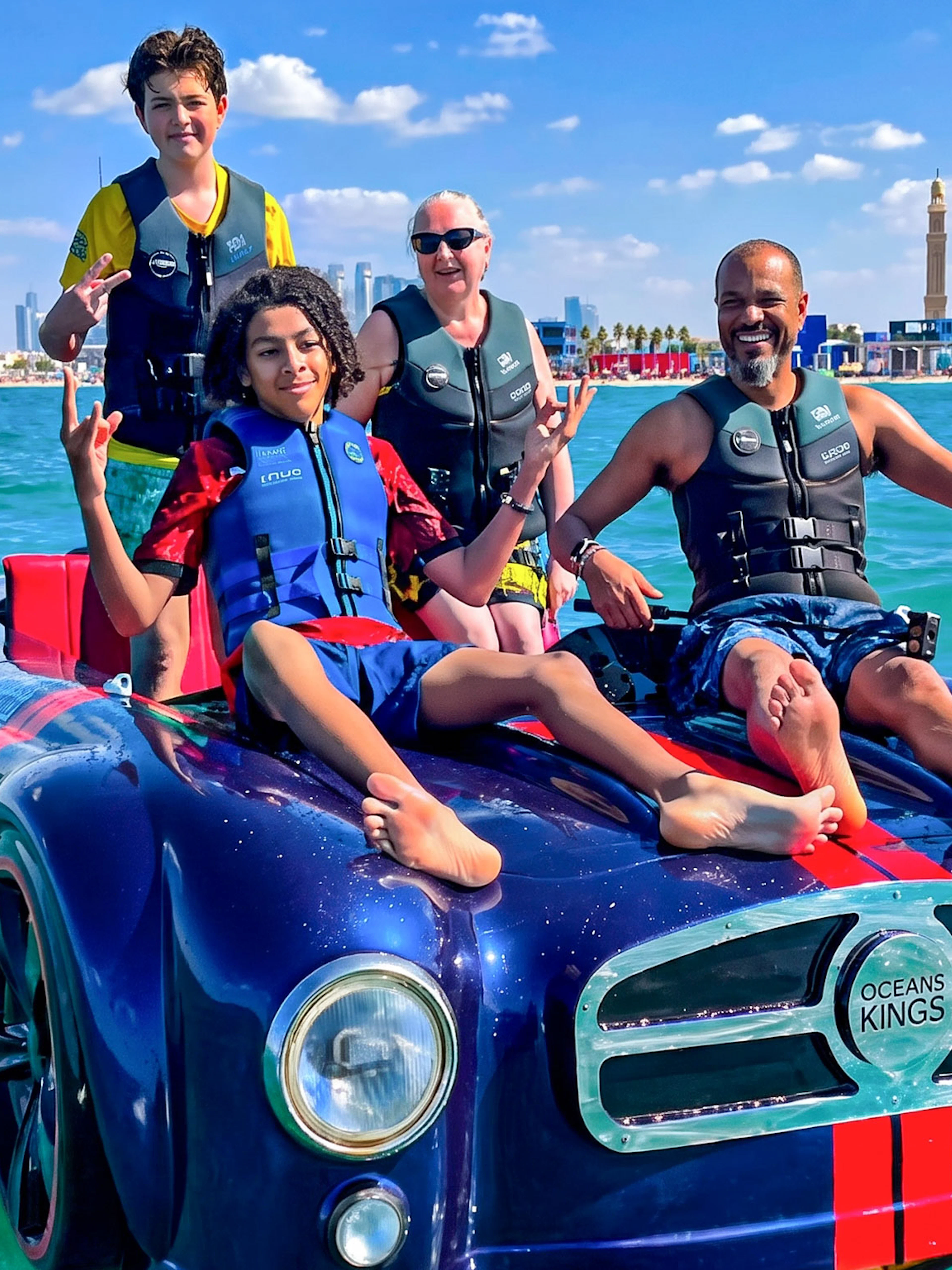 Group enjoying a jetcar ride on the water with Burj Al Arab in the background, Dubai.