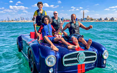 Group enjoying a jetcar ride on the water with Burj Al Arab in the background, Dubai.