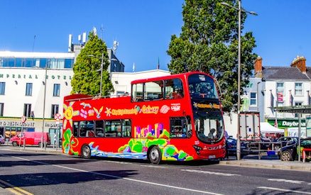 Red double-decker bus on Galway Hop-On-Hop-Off Tour near Imperial Hotel.